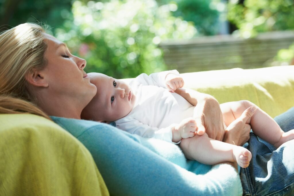 Smiling mother relaxing with baby